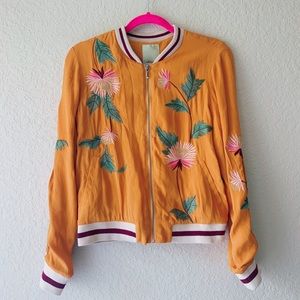 orange bomber jacket with embroidered flowers